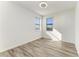 Well-lit bedroom featuring two windows and wood-look flooring at 4852 Coastal Days Ln, Bradenton, FL 34211