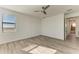 Bright bedroom with wood-look floors and ceiling fan at 4852 Coastal Days Ln, Bradenton, FL 34211