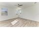 Spacious bedroom with ceiling fan and wood-look floors at 4852 Coastal Days Ln, Bradenton, FL 34211