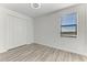 Bedroom with window, closet, and wood-look floors at 4852 Coastal Days Ln, Bradenton, FL 34211