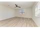 Bright bedroom with wood-look floors and ceiling fan at 4852 Coastal Days Ln, Bradenton, FL 34211