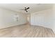 Bright bedroom with wood-look floors and ceiling fan at 4852 Coastal Days Ln, Bradenton, FL 34211