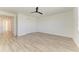 Spacious bedroom with wood-look floors and ceiling fan at 4852 Coastal Days Ln, Bradenton, FL 34211