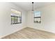 Bright dining room with wood-look tile floors and two windows at 4852 Coastal Days Ln, Bradenton, FL 34211