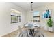 Dining area with a round table and four chairs, a window, and a chandelier at 4852 Coastal Days Ln, Bradenton, FL 34211