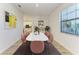 Dining room with marble table and pink chairs, view of kitchen at 4852 Coastal Days Ln, Bradenton, FL 34211