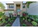 Front entry with stone accents, landscaping, and a walkway at 4852 Coastal Days Ln, Bradenton, FL 34211