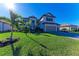 Two-story house with gray siding, landscaping, and a three-car garage at 4852 Coastal Days Ln, Bradenton, FL 34211