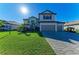 Two-story house with gray siding, tile roof, and a paved driveway at 4852 Coastal Days Ln, Bradenton, FL 34211