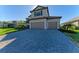 Two-car garage with gray doors and a paved driveway at 4852 Coastal Days Ln, Bradenton, FL 34211