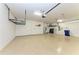 Garage with overhead storage and epoxy flooring at 4852 Coastal Days Ln, Bradenton, FL 34211