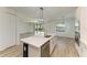 Kitchen island with white quartz countertop and stainless steel dishwasher at 4852 Coastal Days Ln, Bradenton, FL 34211