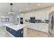 Modern kitchen with white cabinets and a large island at 4852 Coastal Days Ln, Bradenton, FL 34211