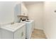 Laundry room with washer, dryer, cabinets, and sink at 4852 Coastal Days Ln, Bradenton, FL 34211