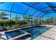 Enclosed pool and spa with a view of the surrounding landscape at 4852 Coastal Days Ln, Bradenton, FL 34211