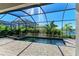 Screened-in pool and spa with paver deck and lake view at 4852 Coastal Days Ln, Bradenton, FL 34211