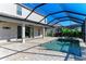 Spacious pool area with covered patio and adjacent house at 4852 Coastal Days Ln, Bradenton, FL 34211