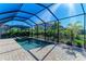 Relaxing screened pool and spa with paved patio and lush landscaping at 4852 Coastal Days Ln, Bradenton, FL 34211