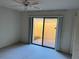 Bright bedroom with sliding glass doors opening to a private patio at 5505 Ashton Lake Dr # 5505, Sarasota, FL 34231