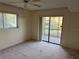 Bedroom with sliding glass doors leading to a private patio at 5505 Ashton Lake Dr # 5505, Sarasota, FL 34231