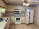 Kitchen features white appliances and light-colored cabinetry at 5505 Ashton Lake Dr # 5505, Sarasota, FL 34231