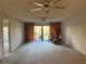 Living room with sliding doors leading to a screened patio and pond view at 5505 Ashton Lake Dr # 5505, Sarasota, FL 34231