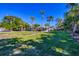 Ranch-style home with a spacious lawn and palm trees at 5602 Cape Leyte Dr, Sarasota, FL 34242