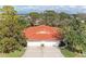 Aerial view of a house with a red tile roof and a three-car garage at 5613 Garden Lakes Dr, Bradenton, FL 34203