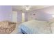 Bedroom with king bed, sitting area, and access to bath at 5613 Garden Lakes Dr, Bradenton, FL 34203