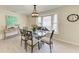 Bright dining area with glass table and seating for six at 5613 Garden Lakes Dr, Bradenton, FL 34203