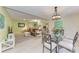 Charming dining room featuring a glass table and neutral decor at 5613 Garden Lakes Dr, Bradenton, FL 34203