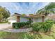 House exterior showcasing landscaping and a two-car garage at 5613 Garden Lakes Dr, Bradenton, FL 34203