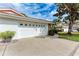 White stucco home with a red tile roof and a two-car garage at 5613 Garden Lakes Dr, Bradenton, FL 34203