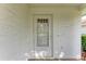 White front door with glass panels, adding curb appeal at 5613 Garden Lakes Dr, Bradenton, FL 34203