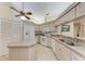 Bright kitchen with granite countertops, white appliances, and an island at 5613 Garden Lakes Dr, Bradenton, FL 34203