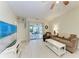 Living room with sliding doors opening to a relaxing patio area at 5613 Garden Lakes Dr, Bradenton, FL 34203