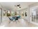 Sunroom with tiled floor, seating area and view of backyard at 5613 Garden Lakes Dr, Bradenton, FL 34203