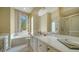 Elegant bathroom with soaking tub, shower, and updated vanity at 5781 Girona Pl, Sarasota, FL 34238