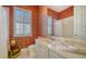 Well-appointed bathroom with patterned wallpaper and updated fixtures at 5781 Girona Pl, Sarasota, FL 34238