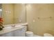 Clean bathroom with toilet, sink, and decorative accents at 5781 Girona Pl, Sarasota, FL 34238