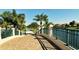 Brick paved bridge walkway with green railing overlooking canal at 5781 Girona Pl, Sarasota, FL 34238