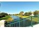 View of a canal with green railing bridge and homes at 5781 Girona Pl, Sarasota, FL 34238