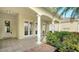 Outdoor patio with columns, tile flooring, and access from multiple doors at 5781 Girona Pl, Sarasota, FL 34238