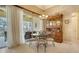 Bright dining room with a charming wooden hutch and glass-top table at 5781 Girona Pl, Sarasota, FL 34238