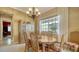 Elegant dining room features a large table, chandelier, and built-in hutch at 5781 Girona Pl, Sarasota, FL 34238