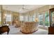 Living room with floral sofas, neutral walls, and plenty of natural light at 5781 Girona Pl, Sarasota, FL 34238