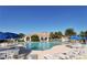 Community pool with lounge chairs and umbrellas at 5781 Girona Pl, Sarasota, FL 34238