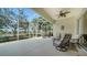 Spacious screened lanai overlooking the lake with comfortable seating at 5781 Girona Pl, Sarasota, FL 34238