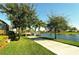 Scenic walking path alongside lake and lush landscaping at 5781 Girona Pl, Sarasota, FL 34238