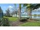 Landscaped waterfront path, serene lake view at 5781 Girona Pl, Sarasota, FL 34238